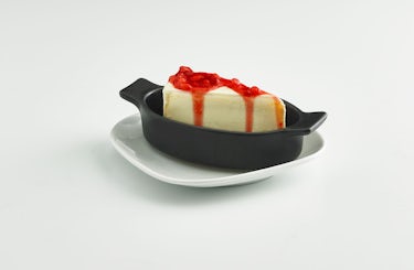 image of NY Cheesecake drizzled in strawberry topping.