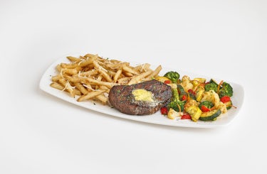 steak plated with fries and roasted veggies