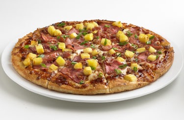 Hawaiian BBQ pizza served on a white plate.