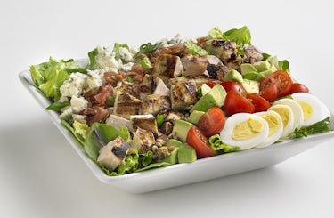 Chicken cobb salad in a square bowl.
