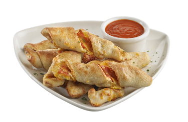 A plate stacked with pepperoni-stuffed twisted bread, with a cup of dipping sauce.